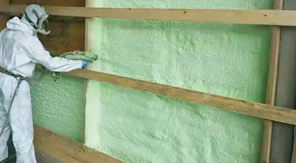 green genyk insulation being installed by Fase Two Insulation Crew Member