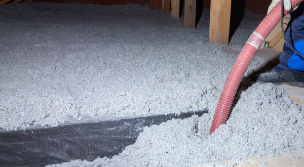 Thermocomfort Cellulose Insulation being blown into attic